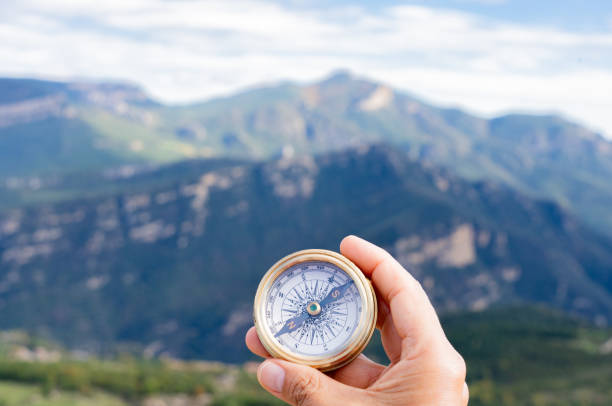 istock Hand holding a compass, guiding the way through summer mountain exploration, embodying the spirit of adventure and discovery in nature 2198944856