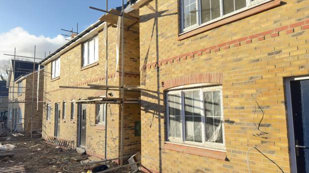 istock Under-Construction Brick Townhouses with Scaffolding 2198944917