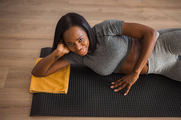 istock Fit woman exercising on floor 2198946498