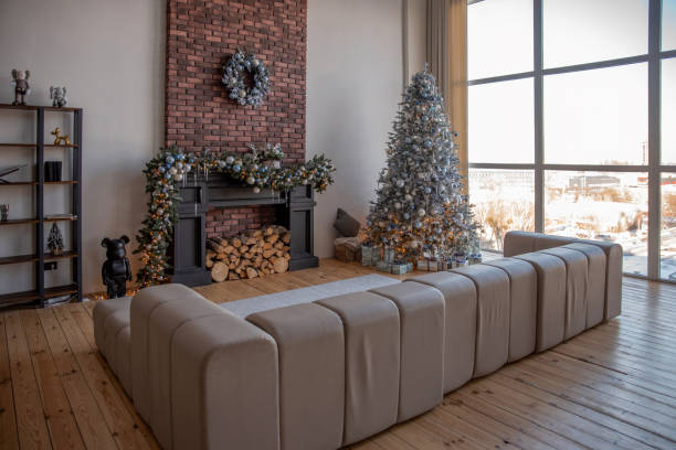 Classical Christmas decorated interior bedroom. Modern classic style interior design apartment with cozy king size bad and Christmas tree with white golden ornament decorations. Christmas eve at home