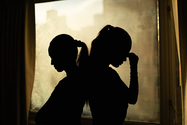 istock Silhouette of two young woman having disagreement, relationship problem, misunderstanding. Sisters rivalry. 2198950047