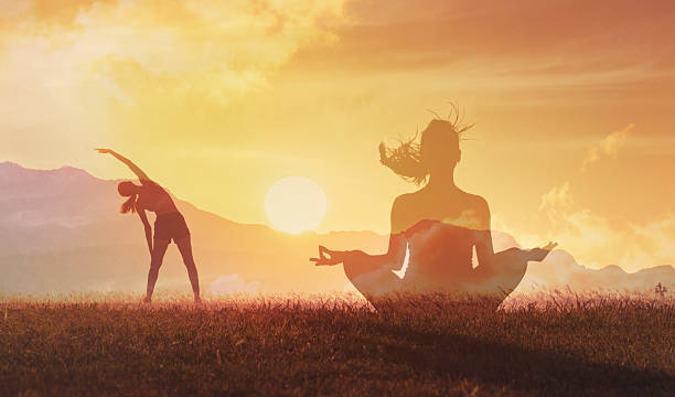 istock Young woman practicing yoga outdoors, stretching and exercising. 2198950378
