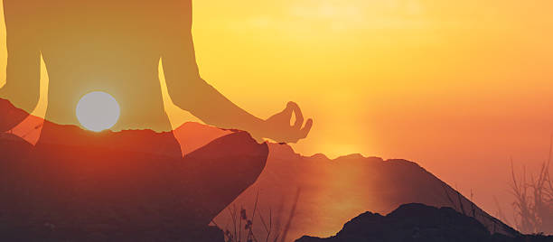 istock Woman meditating in nature at sunset. 2198950463