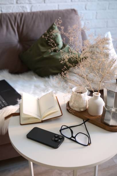 istock A Stylish and Functional Workspace Featuring a Laptop, notebook on sofa and coffee break, glasses, notebook, mobile phone on coffe table.. 2198953413