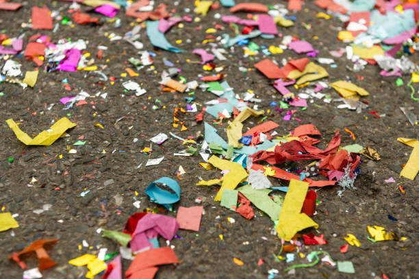 This is a close up photograph of confetti on the city street in Chinatown during Super Saturday, an event during the Lunar New Year in New York City, USA.