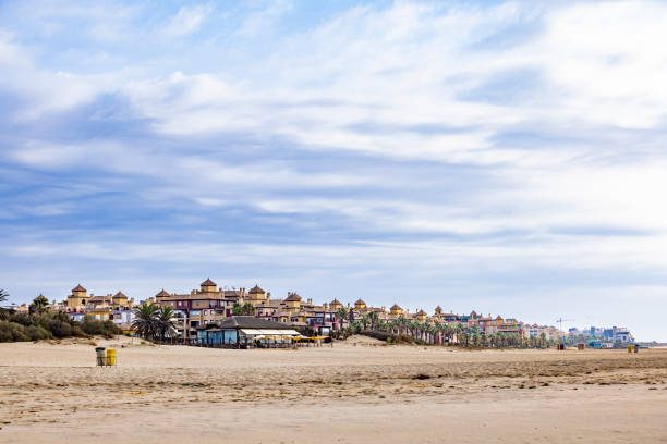 A stunning panoramic view of Isla Canela Beach during low tide, showcasing golden sands, gentle ocean waves, and a serene atmosphere. Perfect for travel, tourism, and coastal lifestyle themes.