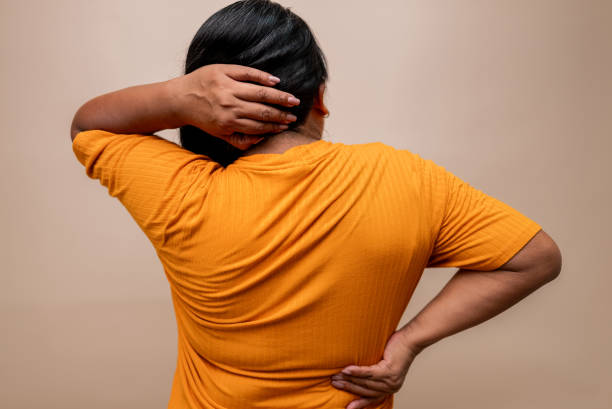 istock Woman with backache at beige background 2198958677
