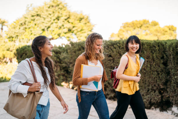 istock Happy exchange students walking and chatting on university campus 2198961937