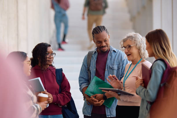 istock Multiracial group of students and their professor communicating in a hallway. 2198962214