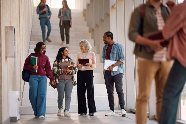 istock Happy teacher and students communicating after a lecture at the university. 2198962241