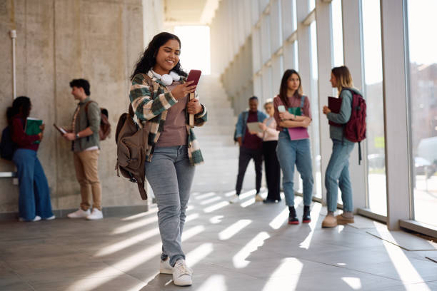 istock Happy Indian student using app on mobile phone at the university. 2198962302