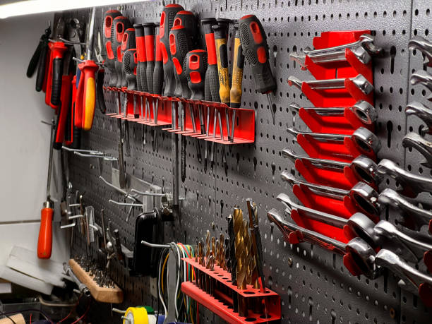 istock Close up of a set of organized different tools hanging on a wall in a garage, rustic workshop scene 2198962476
