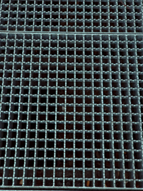 istock A close-up view of a metal grating with a square grid pattern. 2198962776