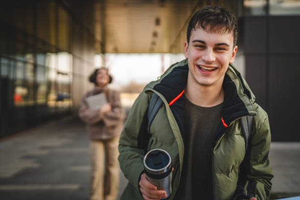 istock man walk outdoor with backpack while drink coffee from thermos 2198964478