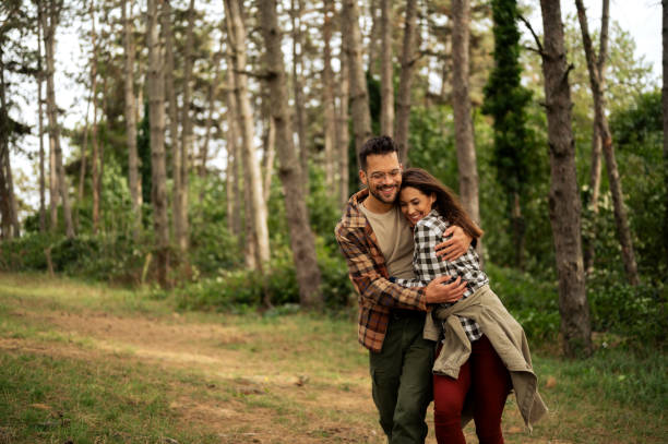 istock Young couple walking through the forrest and exploring nature 2198964524