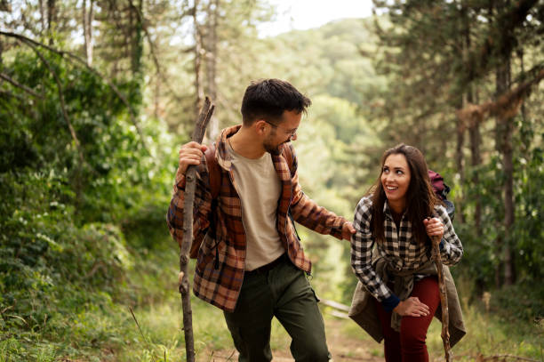 istock Young couple walking through the forrest and exploring nature 2198965559