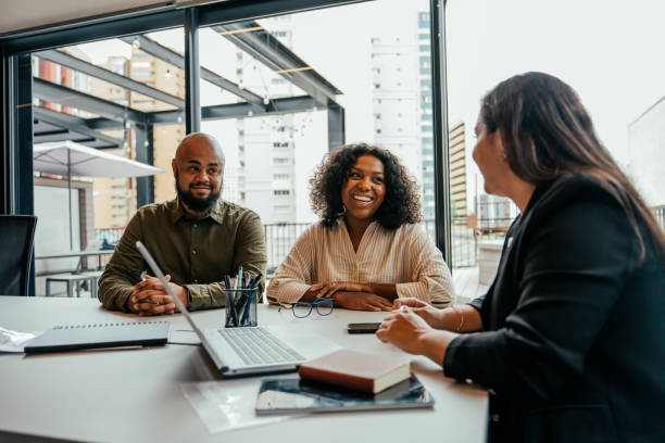 istock Couple talking to real estate agent in office 2198966620