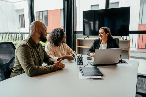 istock Couple talking to real estate agent in office 2198966642