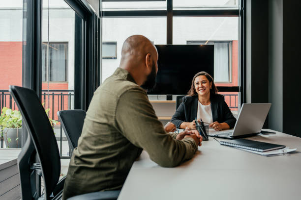 istock Couple talking to real estate agent in office 2198966643