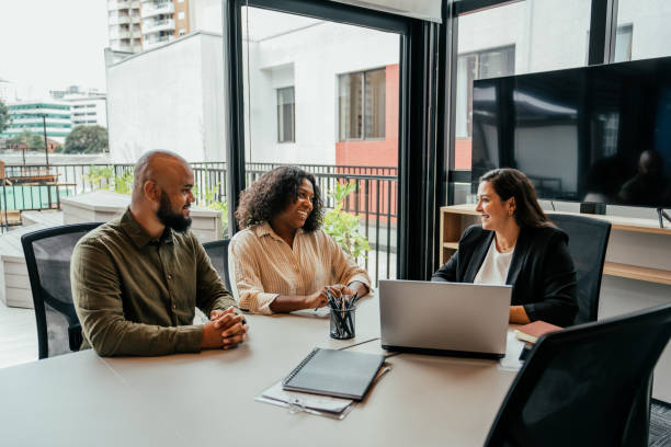 istock Couple talking to real estate agent in office 2198966674