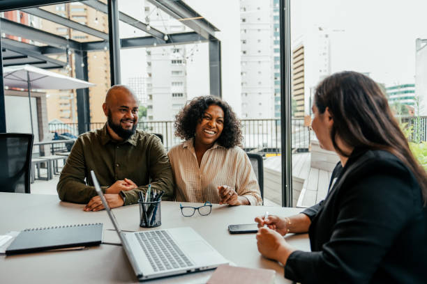 istock Couple talking to real estate agent in office 2198966698