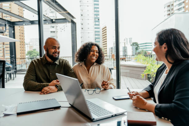 istock Couple talking to real estate agent in office 2198966703