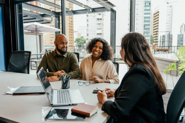 istock Couple talking to real estate agent in office 2198966709