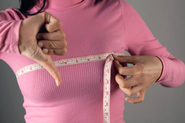 istock young woman measures her bust with a tape measure 2198967334