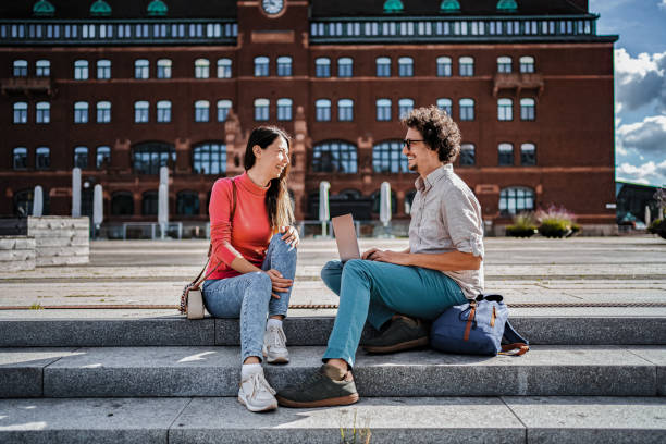 istock Young colleagues working remotely in Malmo, Sweden, using a laptop and smiling 2198967780
