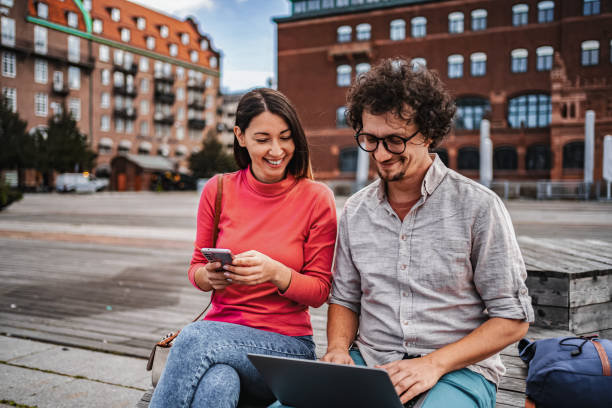 istock Young Couple Working Remotely in Malmo, Sweden, Using Laptop and Smartphone 2198968325