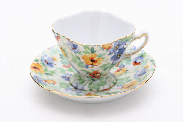 istock Delicate porcelain teacup with vibrant floral design resting on pristine white surface, highlighting minimalist ceramic elegance 2198968493