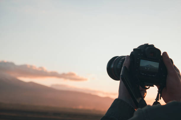 istock young man photographing a mountain 2198969173