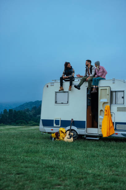 istock Friends enjoying a road trip, relaxing on their campervan roof 2198971542