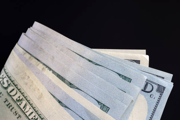 new and old 100 dollar bills stacked together, a group of genuine American cash of one hundred dollars