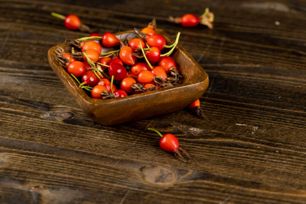 istock red rosehip fruits on a black tea table 2198975854