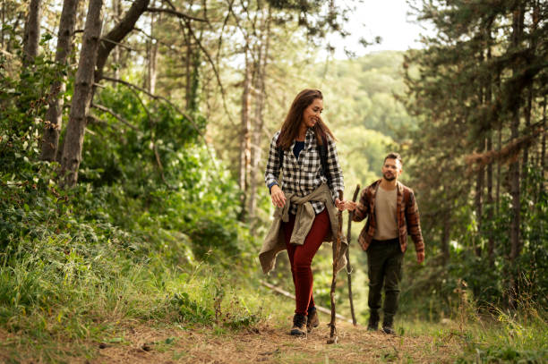 istock Young couple walking through the forrest and exploring nature 2198975974