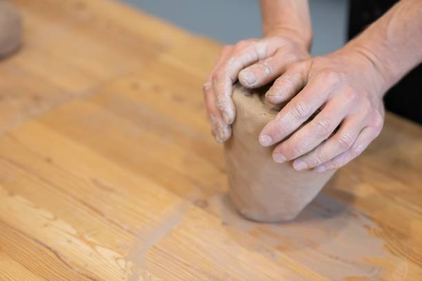 istock A potter kneads clay before using it in the workshop. Close-up of a man's hands. 2198976191