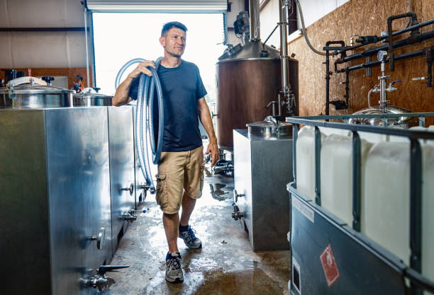 istock Mid adult male whisky distiller working at distillery 2198976614