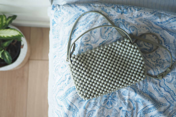 istock This Stylish Beaded Handbag rests elegantly atop a Decorative Pillow, showcasing its beauty 2198977321