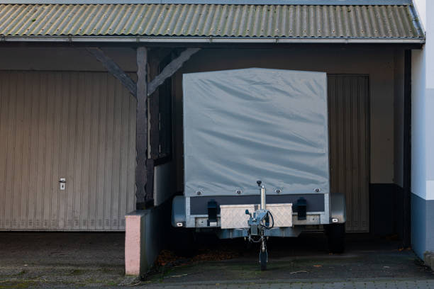 istock Small trailer parked in garage with a gray cover in a quiet area 2198980848