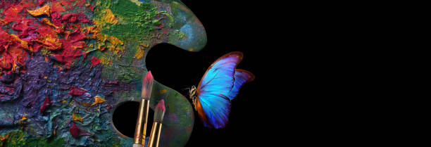 Color concept. Bright blue tropical morpho butterfly on an artist's palette. Copy space
