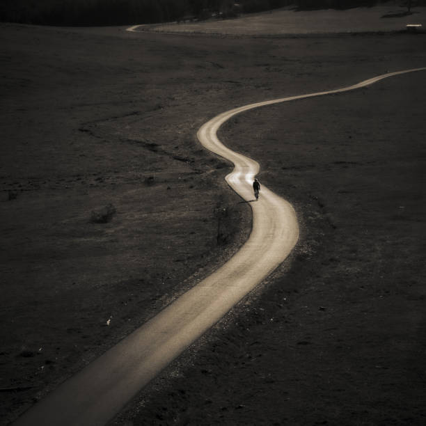 istock Lone cyclist on a curvy road 2198982259