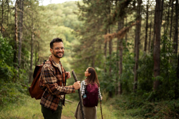 istock Young couple walking through the forrest and exploring nature 2198985889