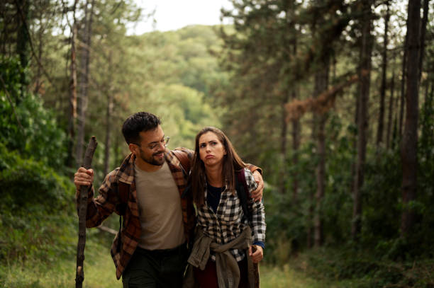 istock Young couple walking through the forrest and exploring nature 2198985906