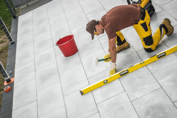 istock A Worker Carefully Lays Tiles Using a Level Tool on a Clean Outdoor Surface in the Afternoon Sun 2198986980
