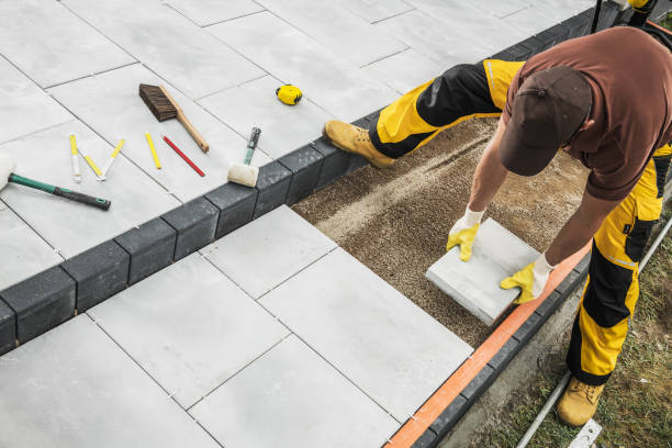 istock Skilled Worker Installs Paving Stones During Landscaping Project on Sunny Day 2198987063