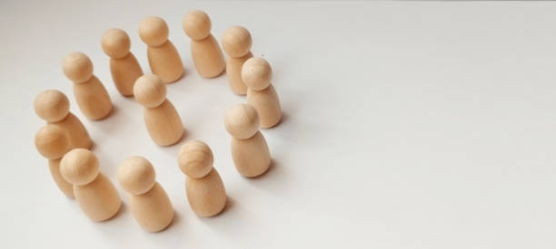 istock Team collaboration event office wooden figurines neutral background top-down view community engagement 2198987194