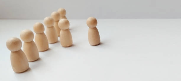 istock Group of wooden figures representing leadership and unity minimalist studio setting conceptual art horizontal view 2198987202