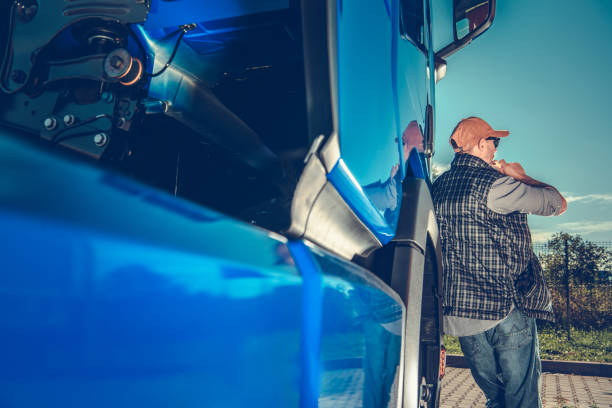 istock Truck Driver Resting by Vehicle Under Clear Blue Sky 2198987213