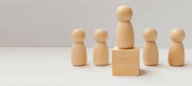 istock Showcasing leadership with wooden figures on display minimalist setting object photography neutral background 2198987220